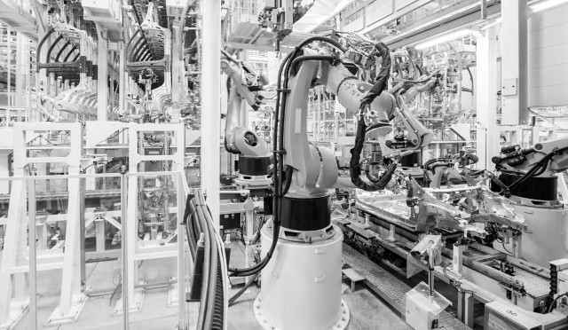 robotic arms in a car plant